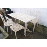 A rectangular cast metal garden table with pierced foliate decoration together with four similar