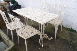 A rectangular cast metal garden table with pierced foliate decoration together with four similar