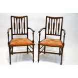 A pair of late19th century mahogany and oak salon chairs with line inlaid back splats and arms over