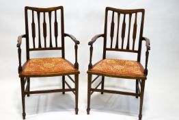 A pair of late19th century mahogany and oak salon chairs with line inlaid back splats and arms over