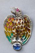 A white metal abstract eagle brooch finished with coloured enamel and set with a ruby to the eye