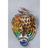 A white metal abstract eagle brooch finished with coloured enamel and set with a ruby to the eye