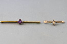 A collection of two bar brooches to include: A stamped 15ct bar brooch with a central amethyst;