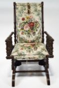 A late 19th century American rocking chair, with turned frame to an upholstered back and seat,