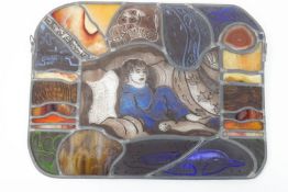 A leaded stained glass and agate panel, depicting a boy on a sofa, marked Annie '10,