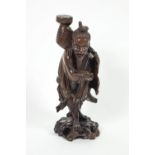 A Japanese root carving of a fisherman on pierced rocky base,