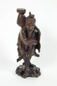 A Japanese root carving of a fisherman on pierced rocky base,