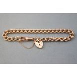 A rose metal curb link bracelet, having padlock safety chain and swivel clasp fittings.