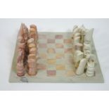 A Kenyan carved soapstone chess set, the King approximately 13.