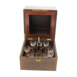 A late 19th century rosewood decanter box, the interior with lift out decanter/glass holder,
