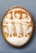 A yellow metal oval cameo brooch with base metal pin together with a pair of oval cameo screw clip