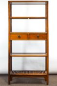 A set of Chinese hardwood shelves with twin central drawers and geometric pieced base shelf,