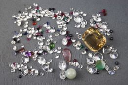 A large collection of loose gemstones to include colourless cubic zirconia, A large citrine quartz,