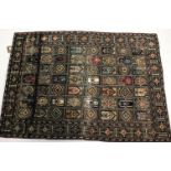 A silk rug, decorated with panels of Mihrabs and geometric designs within a diamond border ,