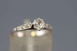 A yellow and white metal single stone ring set with an old European cut diamond estimated to weigh