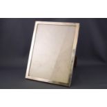 A plain rectangular silver photograph frame with wooden strut back, Birmingham 1952,