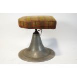 An adjustable stool, with conical metal base and tartan upholstered seat,