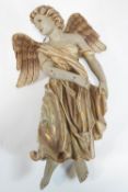 An early 20th century moulded and polychrome painted figure of an Angel,