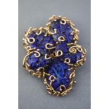 A yellow metal abstract scroll design wire brooch set with carved floral lapis lazuli (untested).