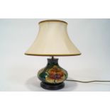 A Moorcroft fire flower pattern baluster lamp on pedestal base,