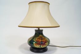 A Moorcroft fire flower pattern baluster lamp on pedestal base,