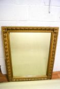 A large wall mirror with gold effect frame,