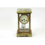 A 19th century French mantel clock, in onyx and brass,
