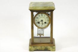 A 19th century French mantel clock, in onyx and brass,