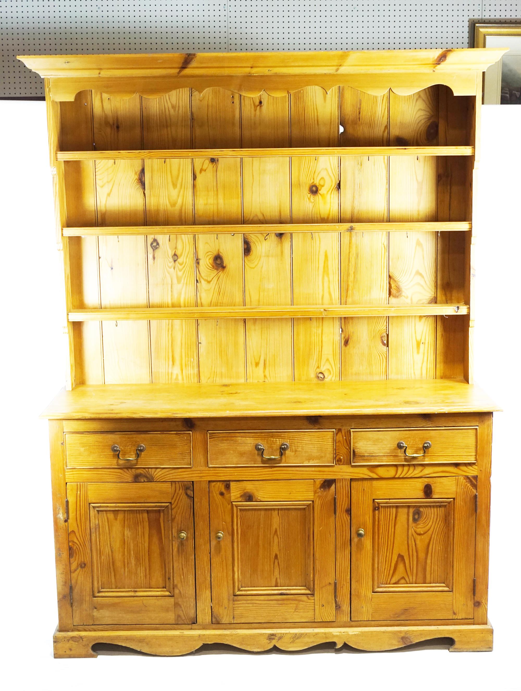 A 20th century pine dresser, the base with 3 drawers above 3 conforming panelled doors,