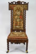 A Victorian mahogany framed nursing chair, with carved scroll crest,