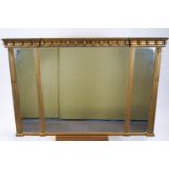 A Regency style rectangular gilt wood three panel inverted front over-mantel mirror with a ball set