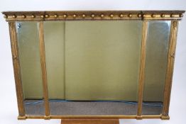 A Regency style rectangular gilt wood three panel inverted front over-mantel mirror with a ball set