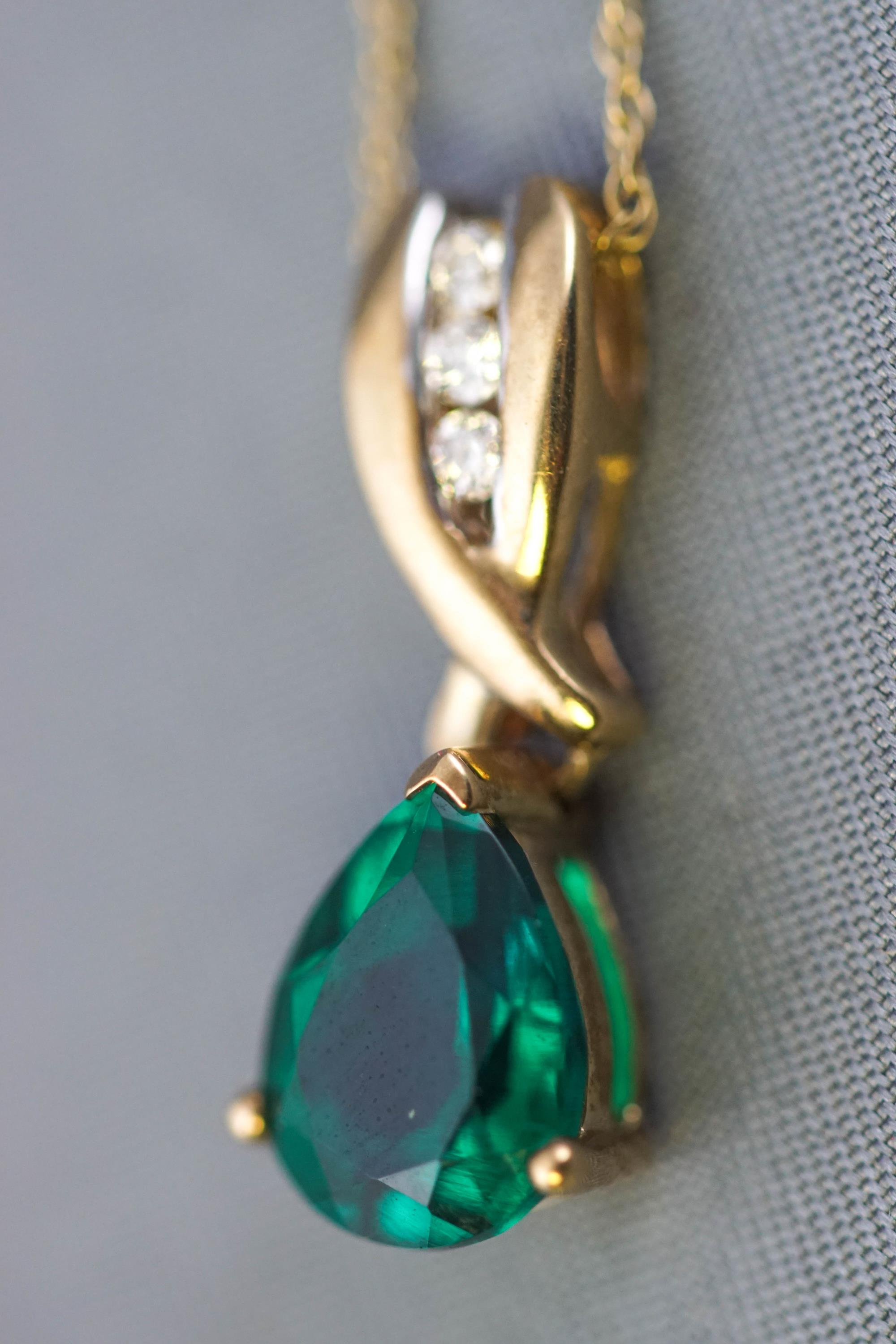 A yellow metal created (synthetic) emerald and diamond pendant suspended from a fine trace link - Image 2 of 2