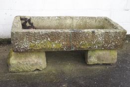 A large carved stone trough on stone base,