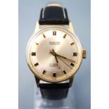 A gold plated wristwatch by J W Benson. Silver circular dial with baton markings.