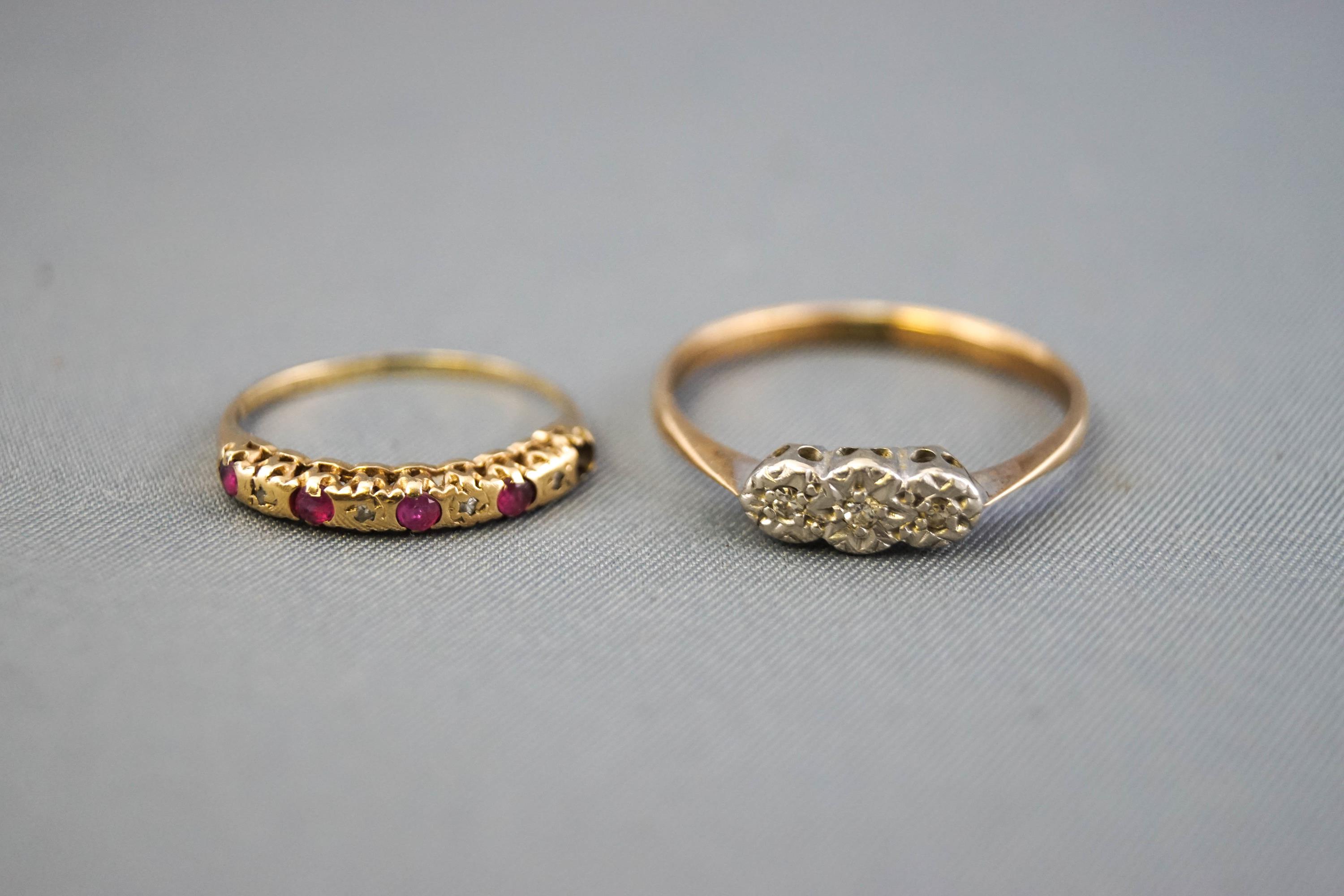 A collection of two dress rings to include: A yellow and white metal illusion set three stone