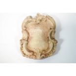 A Rococo style Continental carved marble armorial hatchment, 40cm x 31cm,