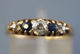 A yellow metal half hoop ring set with a central old european cut diamond measuring approximately 4.