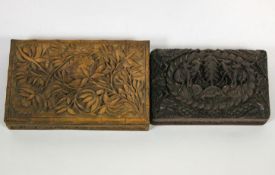 An early 20th century Indian carved hardwood box decorated foliage and another similar,