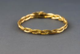 A yellow metal plaited design bracelet with textured finish,