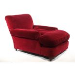 An armchair with long, deep seat, in the style of Howard and Sons,