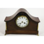 A 19th century mahogany cased mantel clock with arched top, brass columns and feet,