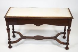 An Edwardian mahogany duet piano stool,