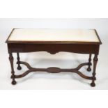 An Edwardian mahogany duet piano stool,