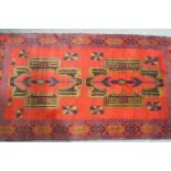 A Baluchi Herati rug with two large medallions on a red field within one wide border,