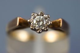 A yellow metal single stone ring illusion set with a round brilliant cut diamond estimated to weigh