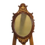 A George II mahogany framed wall mirror, the shaped crest and apron decorated in gilt,