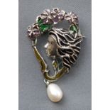 A white metal abstract brooch depicting female profile finished with enamel and a drop freshwater