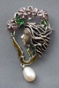 A white metal abstract brooch depicting female profile finished with enamel and a drop freshwater