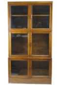 An early 20th Century oak glazed triple bookcase in the Globe Wernicke style,